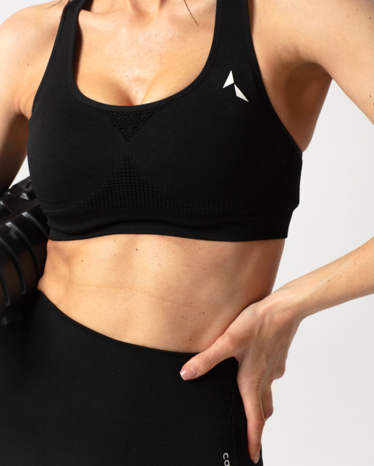 Carpatree Phase Seamless Bra - Black seamless sports bra with removable padding and racer back with crochet style detail.