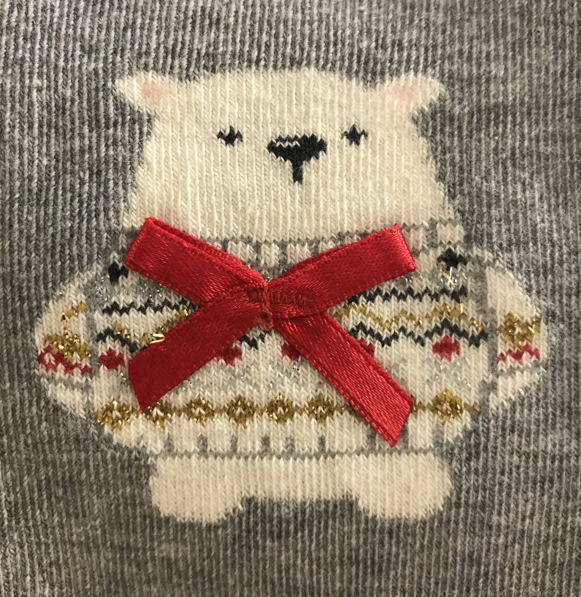 Light grey cotton mix Christmas ankle socks with a cute polar bear wearing a red satin bow and sparkly lurex fairisle style patterned sweater.