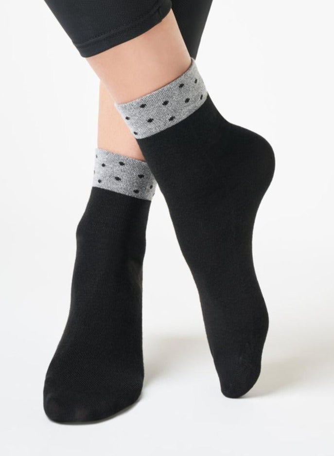 SiSi Pois Calzino - Soft black viscose mix tube ankle socks with a sparkly silver cuff with black polka dot pattern and flat toe seam.